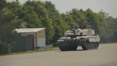 Tank moving quickly on a paved road 1 Stock Footage 110795796