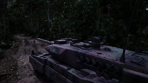 Tank navigating through dense jungle terrain amidst lush greenery Stock Footage 304468105
