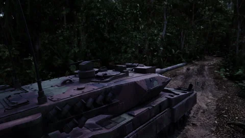 Tank navigating through dense jungle terrain during twilight hours Stock Footage 308529443