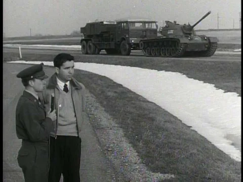 A tank pulls a truck for a field dynamometer test; a truck drives over a wall 스톡 동영상 75277705