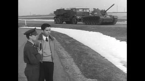 A tank pulls a truck for a field dynamometer test; a truck drives over a wall in 스톡 동영상 93862498