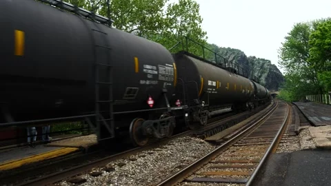 Tanker carriages on a long freight train entering a tunnel Stock Footage 150476265