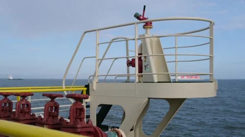 Tanker construction against container ship standing idle Stock Footage 131604913