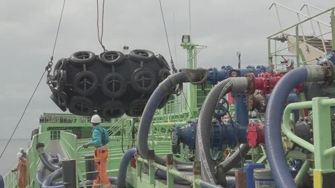 Tanker Onyx skillful workers set large black mooring fenders Stock Footage 119034839