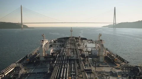 Tanker is proceeding through the strait under bridge, Turkey - time lapse. Stock Footage 77369375