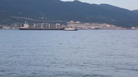 Tanker ship being guided out from port with small boat. Stock Footage 64080820