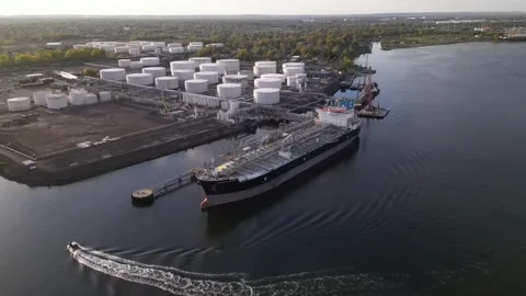 Tanker ship unloading at port, import export oil and gas petrochemical Stock Footage 241954257