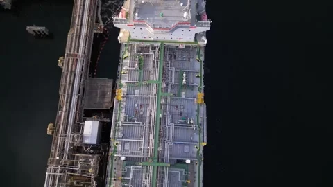 Tanker ship unloading at port, import export oil and gas petrochemical Stock Footage 241954471