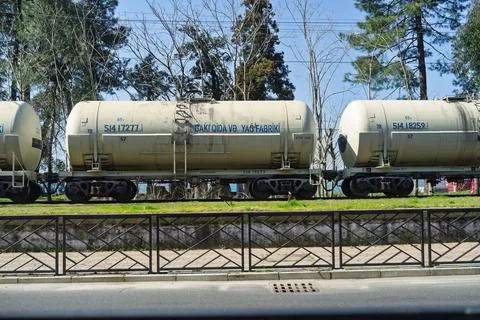 Tanker train transporting cargo along railroad tracks in batumi Stock Photos