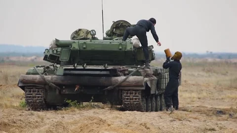 Tankers load shells into a tank, prepare an armored vehicle for a combat mission Stock Footage 319418718