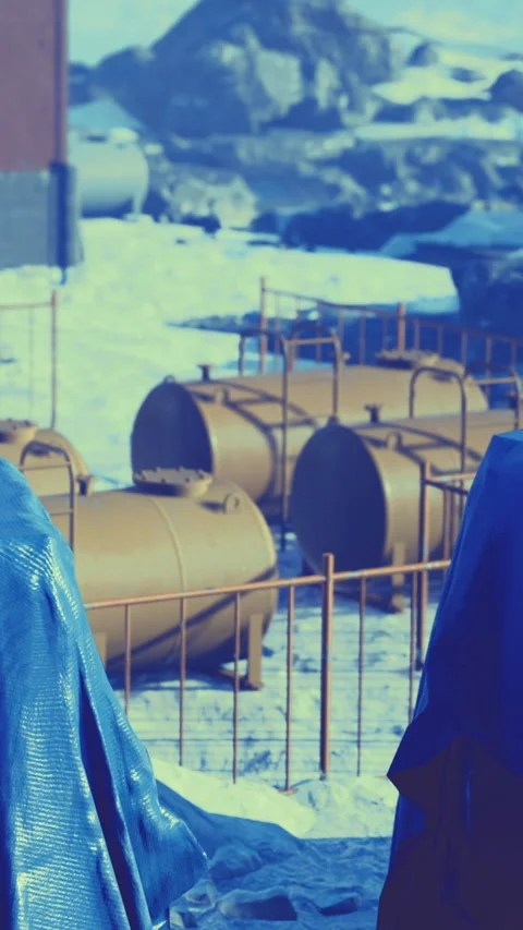 Tanks and equipment at a construction site in a snowy location during winter Video stock 333566515