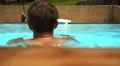 Tanned Muscular Man Swimming in Pool. Slow Motion. HD Footage