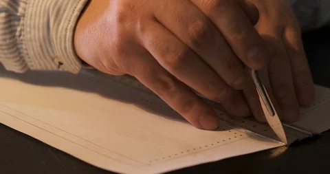 Tanner Creating Template for Leather Product, Hands Knife Cutting Sheet of Paper Stock Footage 129564898