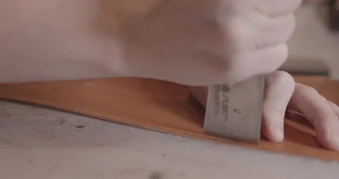 The tanner cuts the skin with a knife, close-up, slow motion 스톡 동영상 147629357
