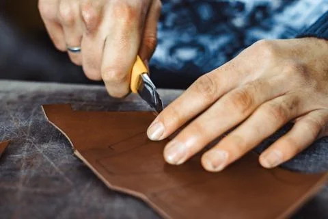 Tanner cuts the skin Stock Photos