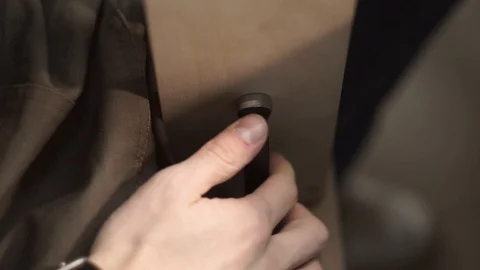 Tanner manually stitches a leather product. Man sews a brown leather wallet Stock Footage 104928023