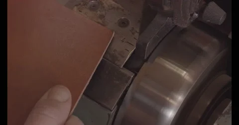 The tanner processes the edges of the leather Stock Footage 147497984