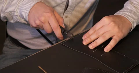 Tanner Processes Leather Edges, Young Craftsman Creates Leather Purse, Handmade Stock Footage 133007911