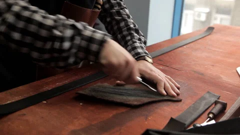 Tanner sharpens the tool to work with the skin Stock Footage 86660094