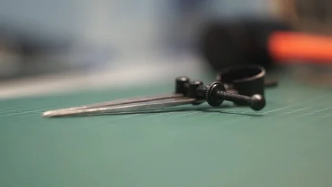 The tanner takes a marking tool from the table. Whiteboard, close-up. Metal Stock Footage 104927627
