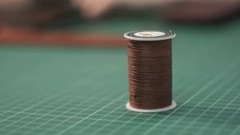 The tanner takes a skein with leather threads from the marking board. Close-up Stock Footage 104927082