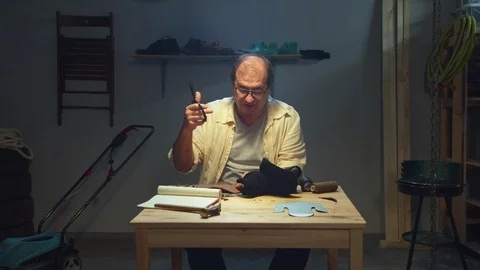 Tanner talks about working with leather and scissors Stock Footage 127835140