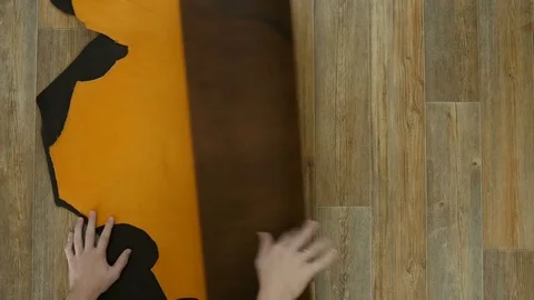 Tanner unfolds the leather on the table 스톡 동영상 81434306