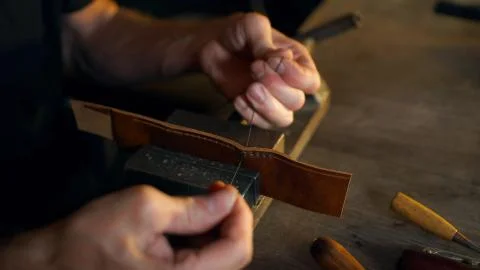 Tanner working with leather. Stock Photos