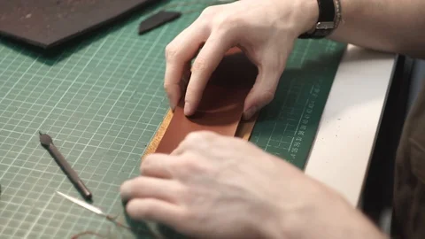 Tanner works in the workshop. Sitting at the table sticks together the details Stock Footage 104926638
