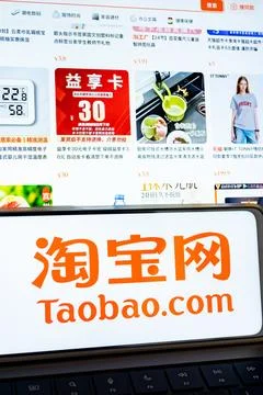 Taobao.Com logo on smartphone screen with e commerce website Stock Photos