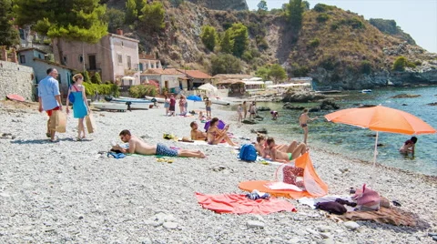 Taormina Sicily People Sunbathing on European Beach Stock Footage