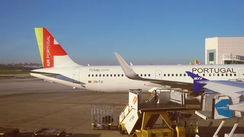 Tap airplane moving backwards undocking from jet bridge Stock Footage 110816958