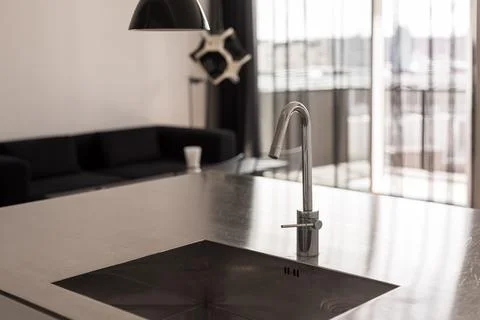 Tap and sink in kitchen interior. Blurry Background Stock Photos