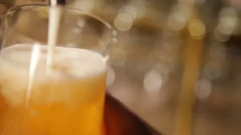 Tap beer being poured in a glass, foamy Stock Footage