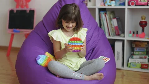 Tap on the bubbles. The toy in the form of a circle turns around. Soothing toy Stock Footage 194748925