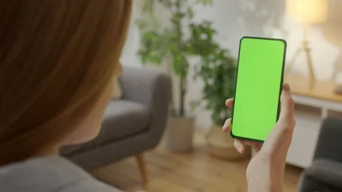 Tap to Click on Centre of Screen. Back View of Woman at Phone with Green Screen Stock Footage 171140141