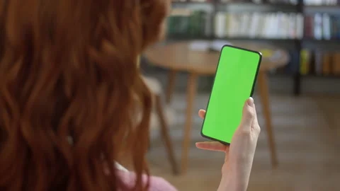 Tap to Click on Centre of Screen. Back View of Woman at Phone with Green Screen Stock Footage 171299603