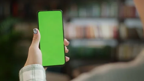 Tap to Click on Centre of Screen. Back View of Man at Phone with Green Screen Stock Footage 205802783