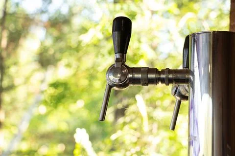 Tap for dispensing drinks on the background of greenery in parks in Ukraine 写真素材