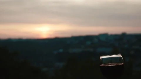 Tap into glasses of wine at sunset Stock Footage