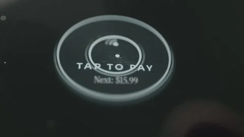 Tap to Pay terminal screen for transactions, finger taps the digital option Stock Footage 332492952