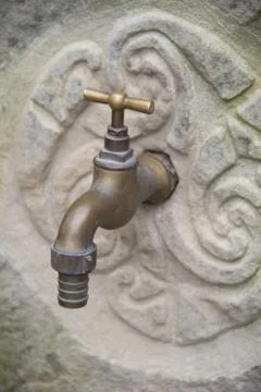 Tap on stone wall Stock Photos