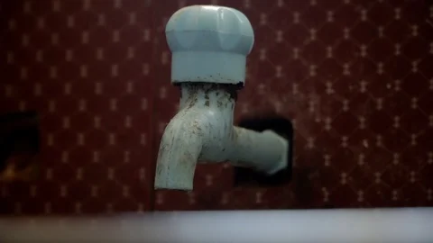 Tap water dipping down closing with hands pollution wastage close up 4k house Stock Footage 123724942