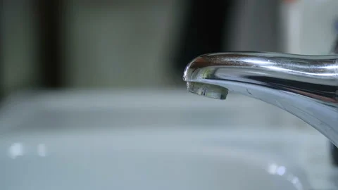 Tap Water dripping wastage,falling potable water drop,pure water conservation Stock Footage 150910238