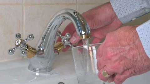 Tap water flows into the cup 4K 動画素材 239440658