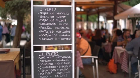 Tapas menu and people eating in the background.  Granada, Spain. Видео 55731459