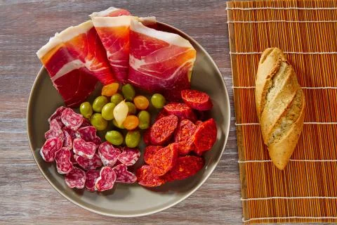 Tapas of Spain with ham bread olives sausages Stock Photos