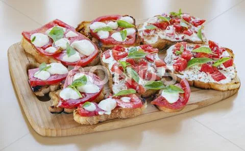 Tapas toasts cheese tomatoes Stock Photos