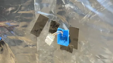 Tape around receptacles with black to hide plan cracks Stock Footage 334045797