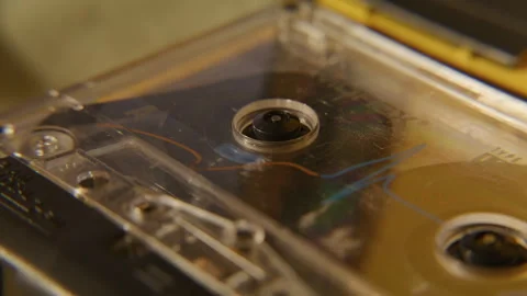Tape casette playing inside portable cassette player - extreme close up Video stock 325460648